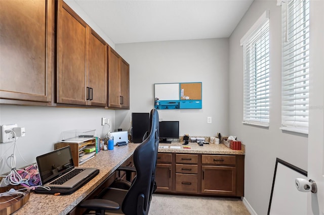 office area featuring built in study area and baseboards