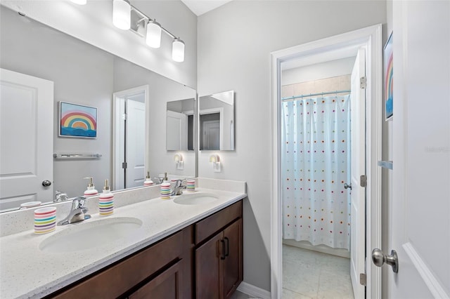 full bathroom with a sink, a shower with shower curtain, double vanity, and tile patterned flooring