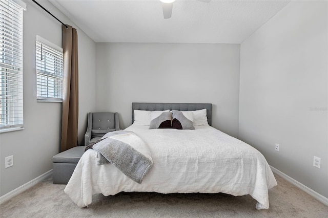 bedroom featuring baseboards, carpet floors, and ceiling fan