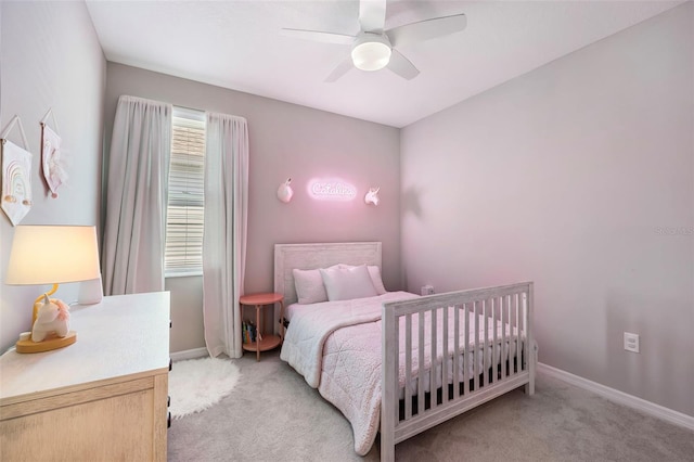 bedroom with light carpet, ceiling fan, and baseboards