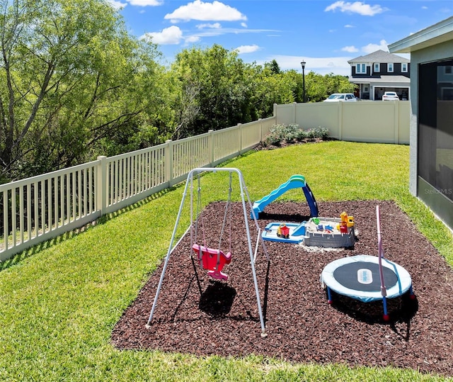 view of yard with a playground and a fenced backyard