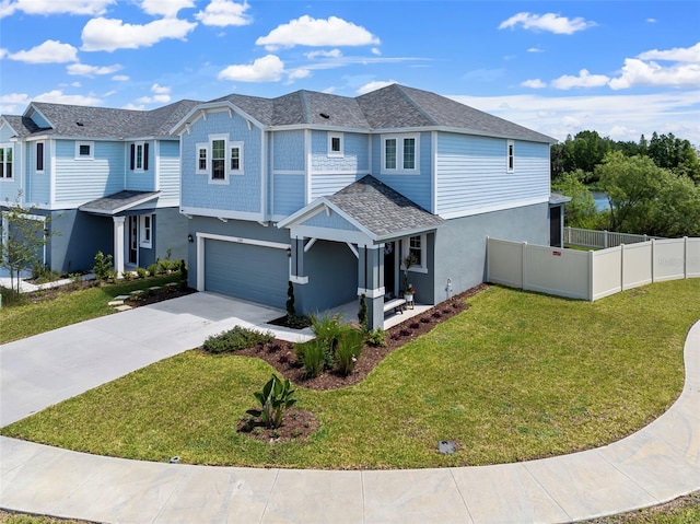 view of front of property with stucco siding, a front lawn, driveway, fence, and an attached garage