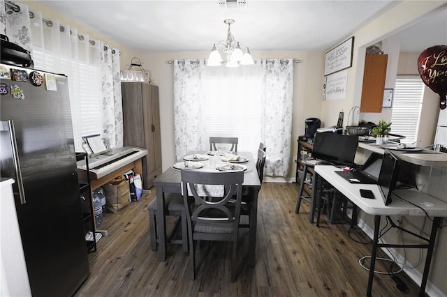 dining room featuring a notable chandelier, baseboards, and dark wood-type flooring