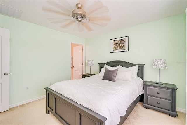 bedroom featuring a ceiling fan, light colored carpet, visible vents, and baseboards