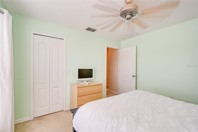 carpeted bedroom with baseboards, a closet, visible vents, and a ceiling fan