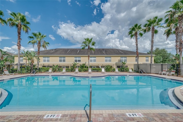 pool with a residential view and fence