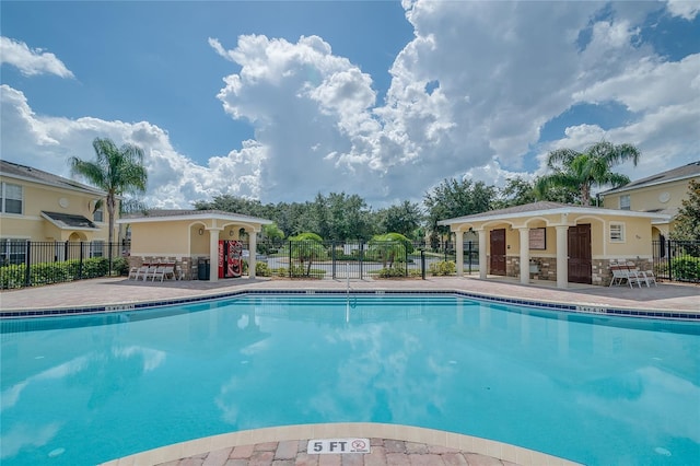 pool featuring a patio area and fence