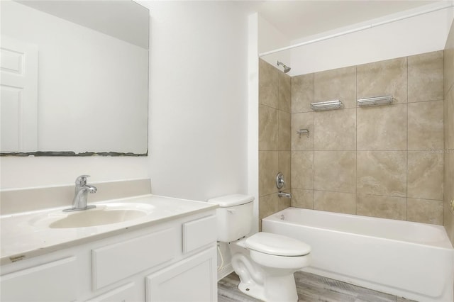 full bath with toilet, vanity, wood finished floors, and shower / bath combination