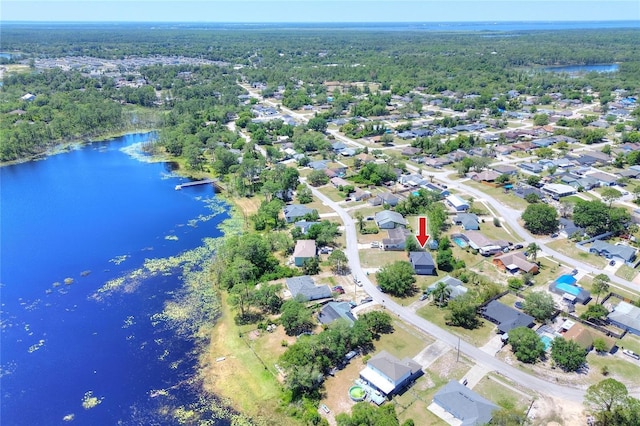 birds eye view of property featuring a wooded view and a water view