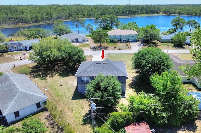 aerial view featuring a wooded view and a water view