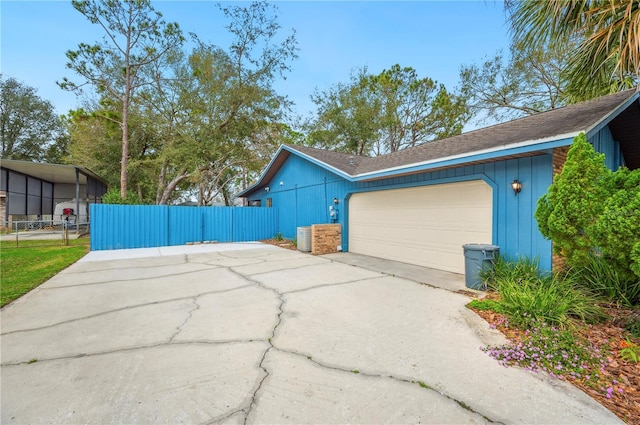 view of side of home featuring a garage and a carport