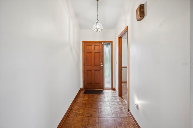 doorway to outside featuring dark parquet flooring