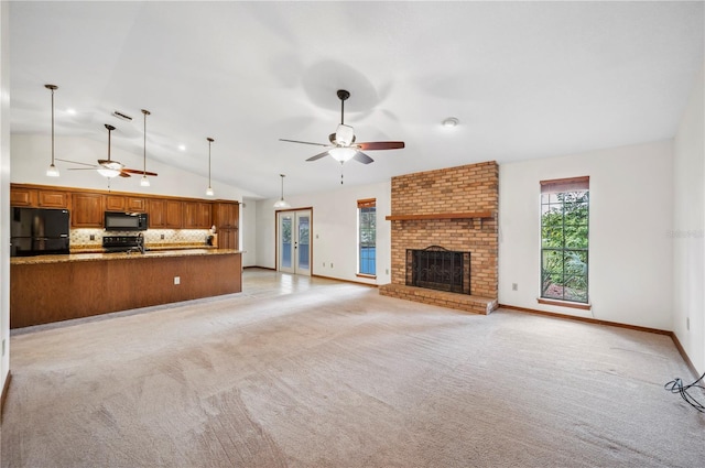 unfurnished living room with a brick fireplace, high vaulted ceiling, ceiling fan, and light colored carpet