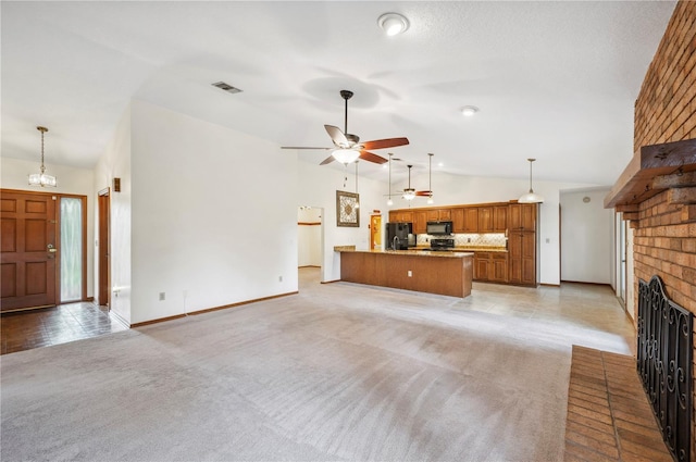 unfurnished living room with a brick fireplace, high vaulted ceiling, ceiling fan with notable chandelier, and light colored carpet