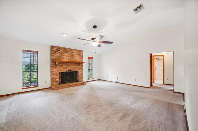 unfurnished living room featuring a brick fireplace, lofted ceiling, and light colored carpet