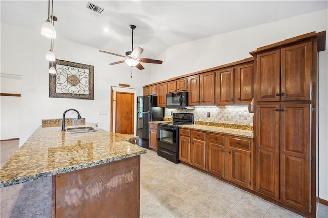 kitchen with sink, black appliances, kitchen peninsula, hanging light fixtures, and tasteful backsplash