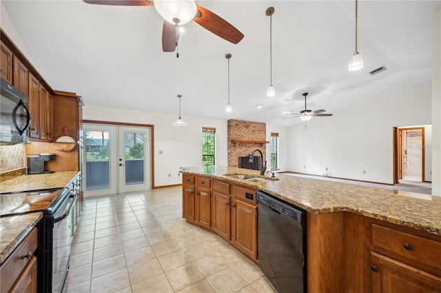 kitchen featuring sink, pendant lighting, black appliances, french doors, and light stone countertops