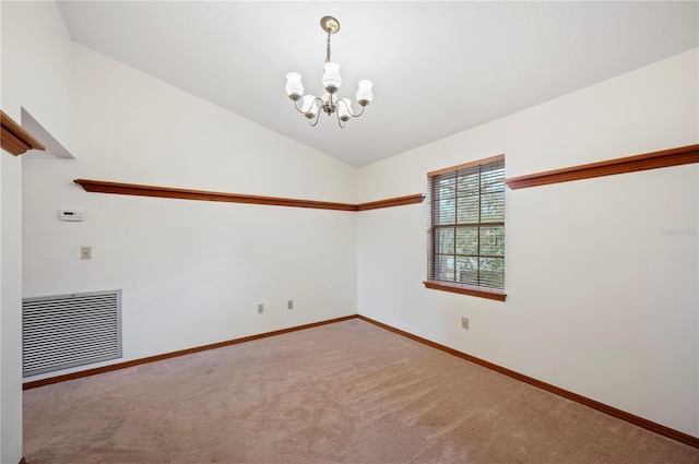 carpeted spare room with an inviting chandelier and lofted ceiling