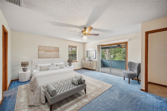 carpeted bedroom with ceiling fan, access to exterior, and a textured ceiling