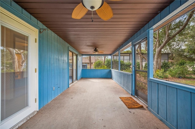 unfurnished sunroom featuring ceiling fan and wooden ceiling