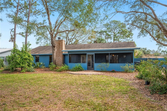 single story home with a front lawn and a sunroom