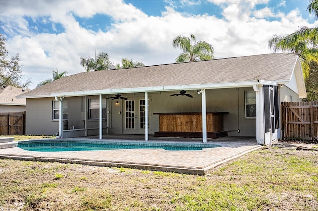 rear view of house with a swimming pool with hot tub, french doors, ceiling fan, and a patio area