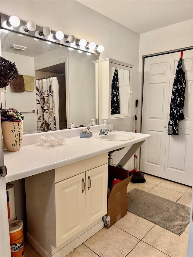 bathroom with tile patterned flooring and vanity