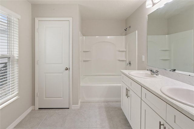 full bathroom featuring tile patterned flooring, a sink, and baseboards