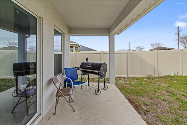 view of patio featuring a fenced backyard and grilling area