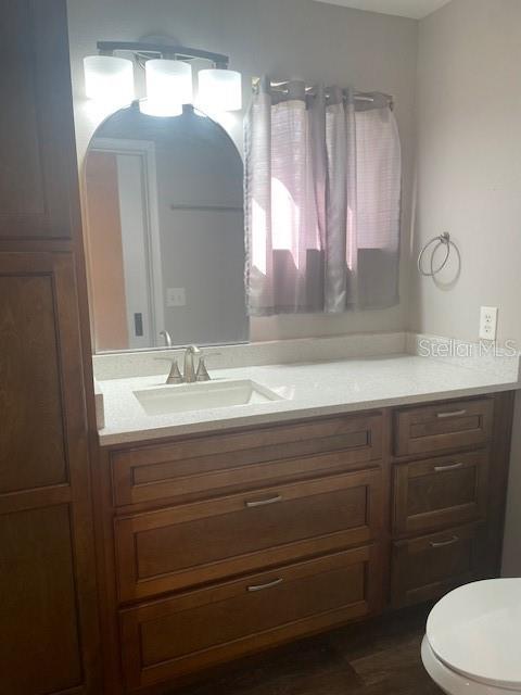 bathroom featuring vanity and toilet