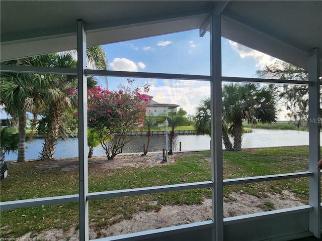 sunroom / solarium featuring a water view