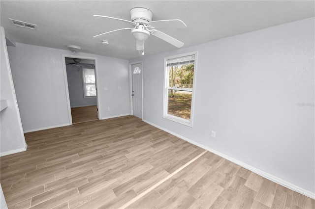 spare room featuring ceiling fan and light hardwood / wood-style floors