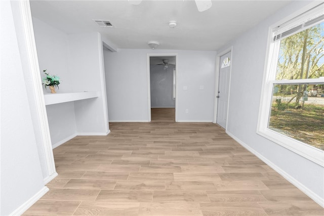 unfurnished room with light wood-type flooring and ceiling fan