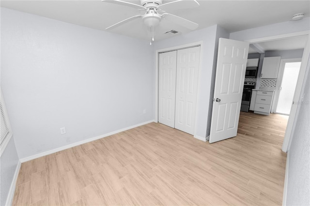 unfurnished bedroom featuring ceiling fan, a closet, and light hardwood / wood-style floors