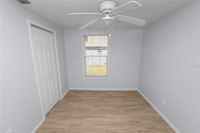 unfurnished room featuring light hardwood / wood-style floors and ceiling fan