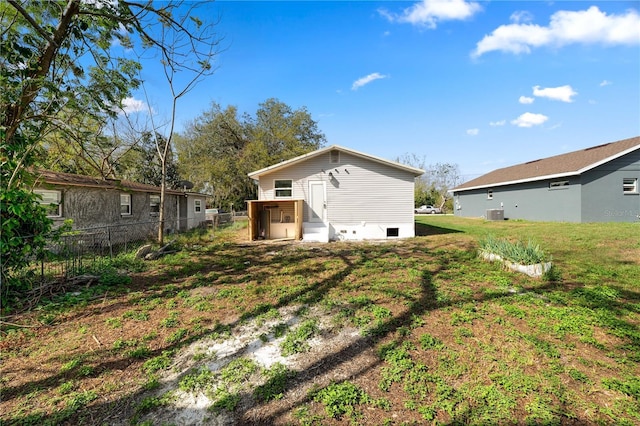 rear view of house featuring a yard and cooling unit