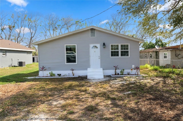 bungalow-style home with central AC and a front yard