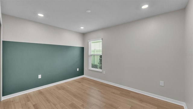 spare room with light hardwood / wood-style flooring