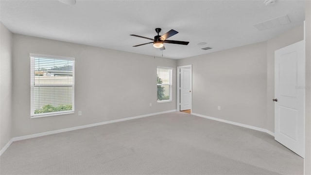 carpeted spare room with ceiling fan