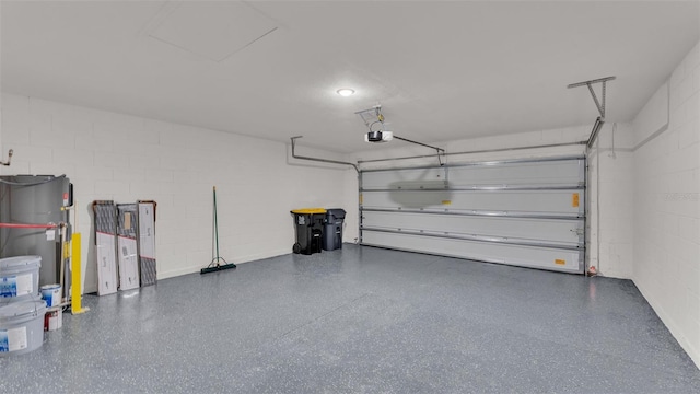 garage featuring water heater and a garage door opener