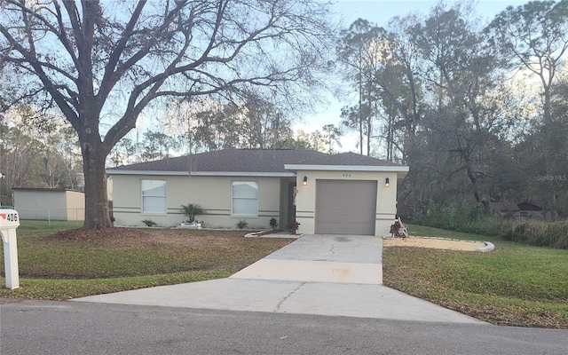 ranch-style home with a front yard, driveway, an attached garage, and stucco siding