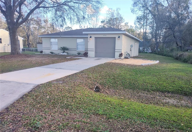 ranch-style home featuring driveway, a garage, stucco siding, roof with shingles, and a front yard