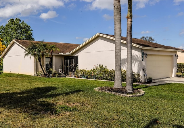 view of front of house with a front yard and a garage