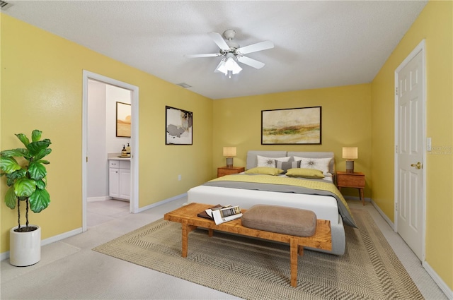 3976 Cypress Lndg W, Winter Haven, FL 33884 - bedroom with light carpet, ensuite bath, and a ceiling fan