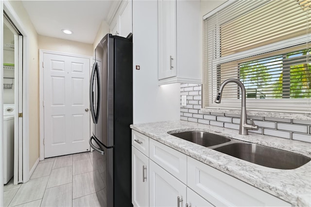 3976 Cypress Lndg W, Winter Haven, FL 33884 - kitchen with freestanding refrigerator, white cabinetry, backsplash, light stone countertops, and recessed lighting