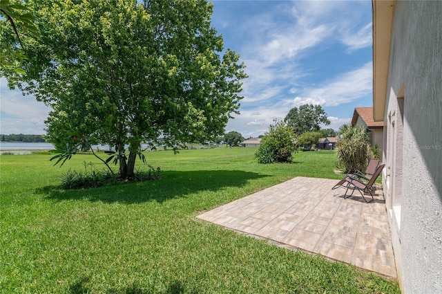 3976 Cypress Lndg W, Winter Haven, FL 33884 - view of green lawn with a patio and a water view