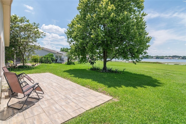 3976 Cypress Lndg W, Winter Haven, FL 33884 - view of green lawn with a water view and a patio area