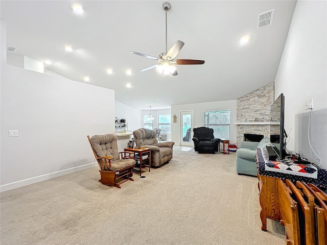 living room with high vaulted ceiling, a fireplace, a ceiling fan, and light colored carpet