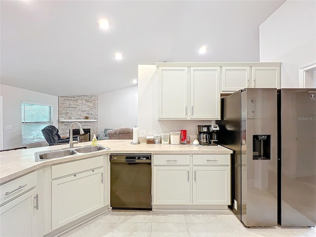 kitchen with stainless steel refrigerator with ice dispenser, light countertops, white cabinets, a sink, and dishwasher