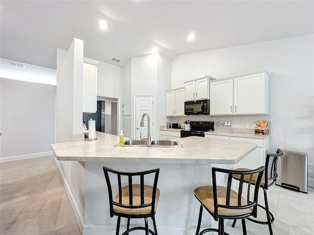 kitchen featuring a sink, black appliances, light countertops, and white cabinets